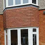 Modern white PVC patio doors with side windows for home extension, double-glazed for insulation.