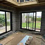 Modern black sliding glass patio doors for residential extension, high-quality UPVC window installation.
