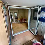 Aluminium bi-fold door installation for enhanced natural light and seamless indoor-outdoor connection.