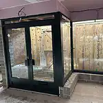 Modern black-framed glass extension installation by CP Glazing Ltd, enhancing property aesthetics.