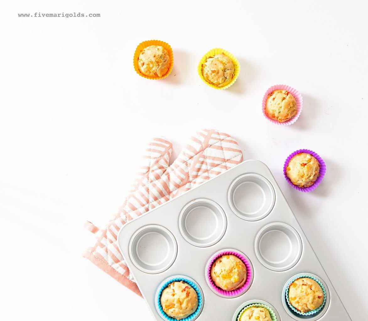 veggie muffins in silicone liners next to muffin pan