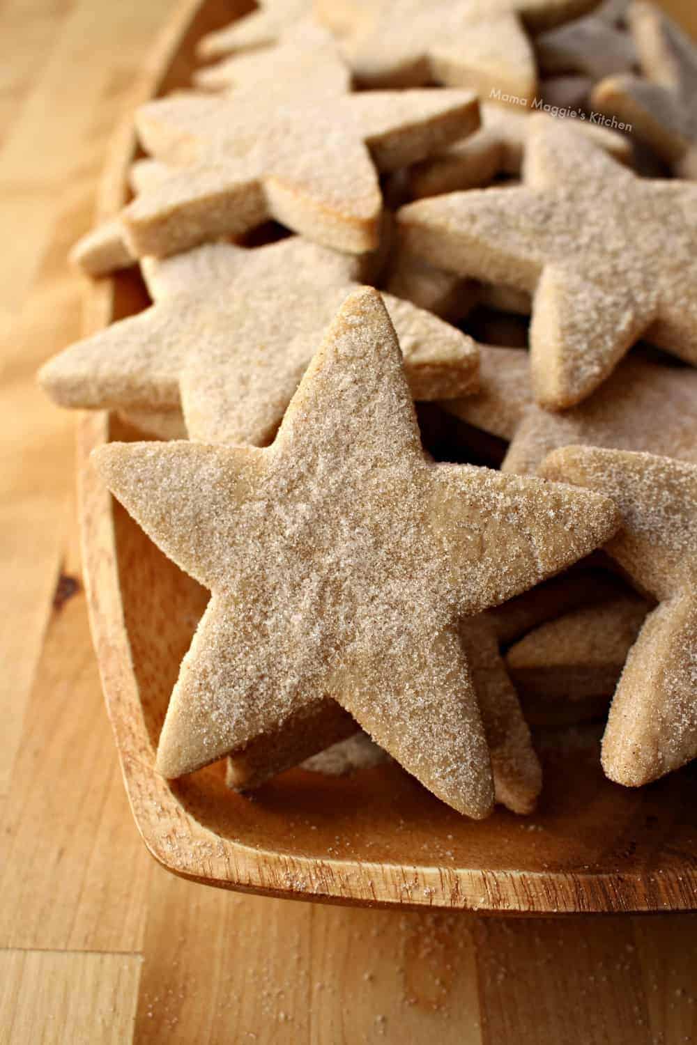 plate of Hojarascas Mexican Shortbread cookies cut into stars and dusted with cinnamon sugar