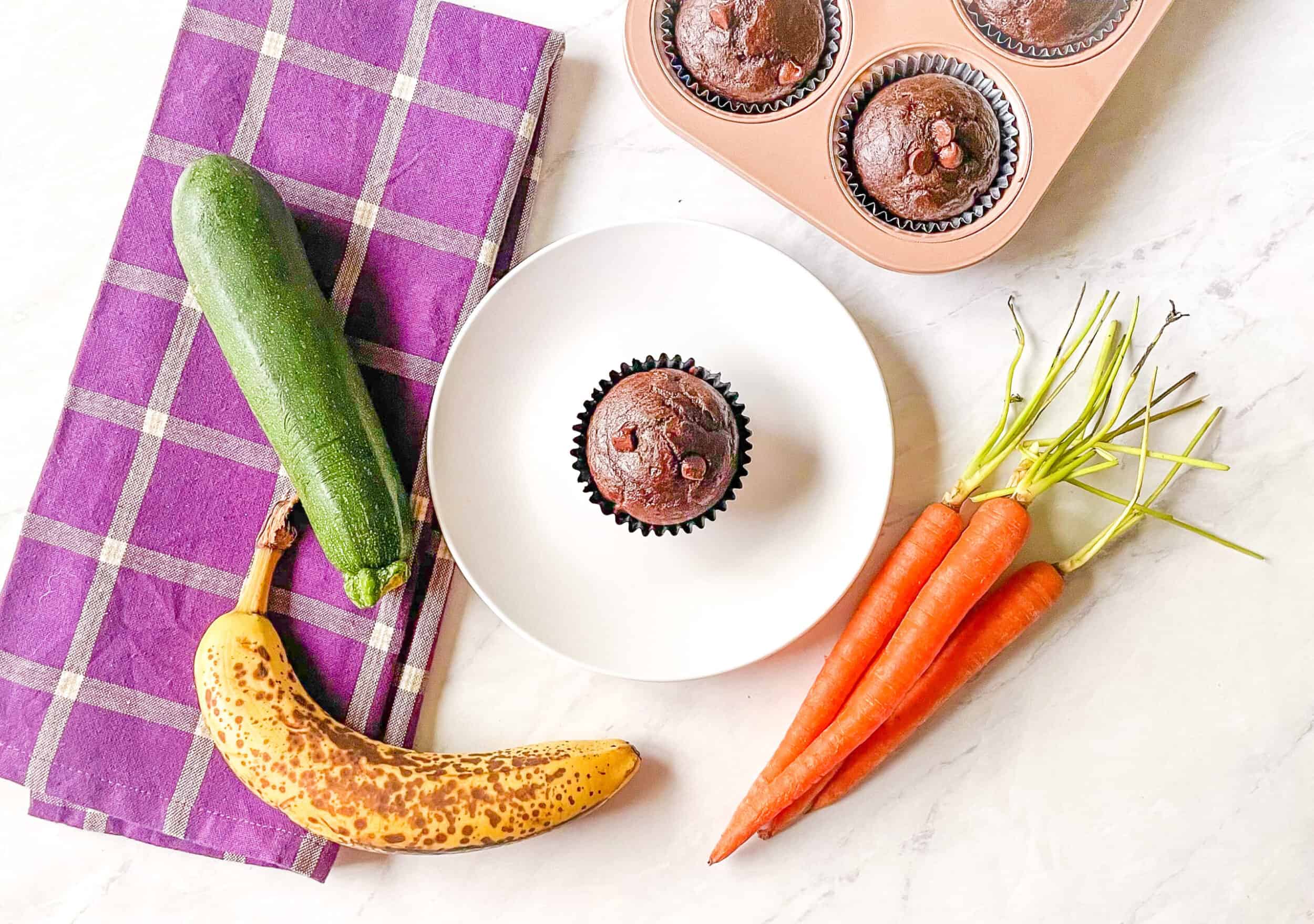 Photo of carrots, zucchini, banana and a chocolate muffin