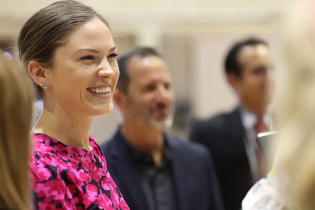 Engaged women at Florida Institute of Classical Learning event, promoting classical education and community leadership.