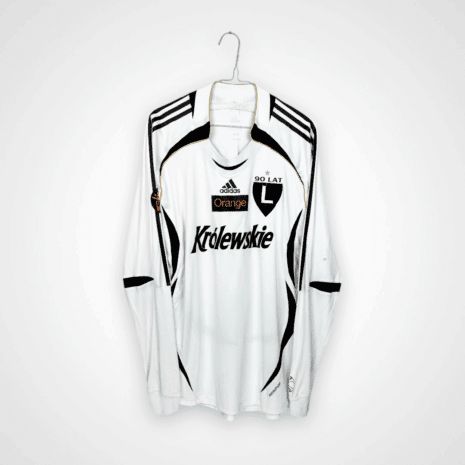 Koszulka piłkarska Legia Warszawa, 2006/07 Home, stan słaby - kilka dziur na lewym rękawie, pęknięcie na herbie klubowym, drobna plamka oraz zaciągnięcie na plecach.