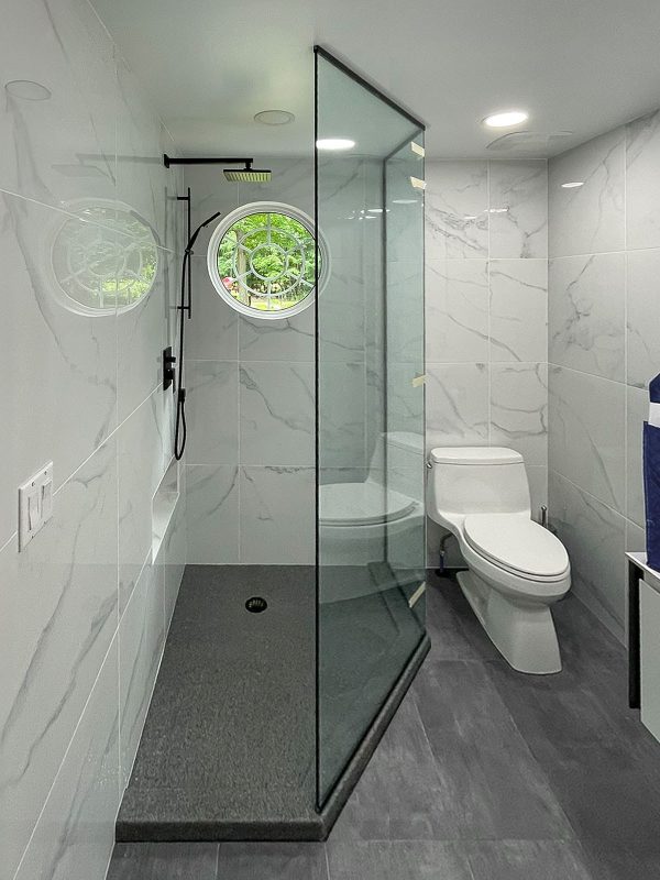 project fort showers open entry custom floor to ceiling angled headers