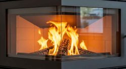 Modern custom glass fireplace with sleek enclosure, showcasing professional design and installation services offered by Fort Glass.