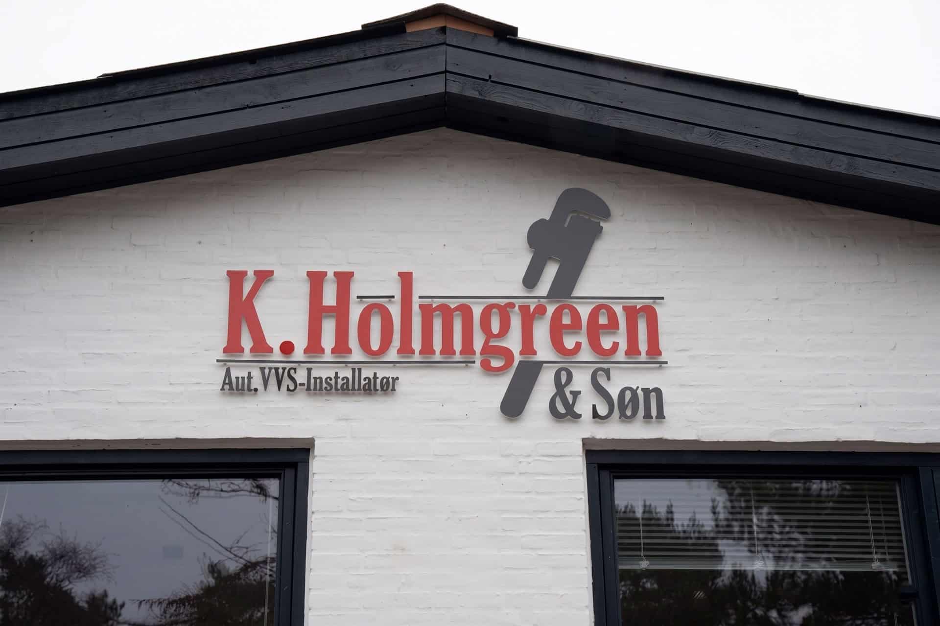 Facadeskilt på bygning med VVS-firmaets logo - "K. Holmgreen Aut. VVS-Installatør & Søn".