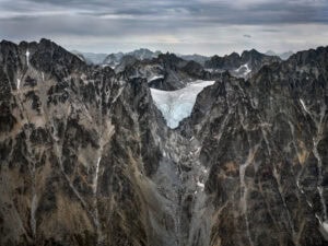 A large glacier is seen in the mountains. Edward Burtynsky, Coast Mountains series.