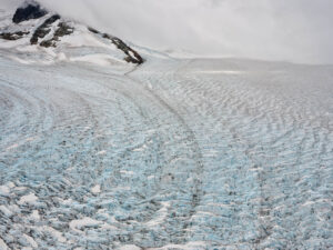 Wind-swept glacial ice at the base of a mountain. Edward Burtynsky, Coast Mountain series.