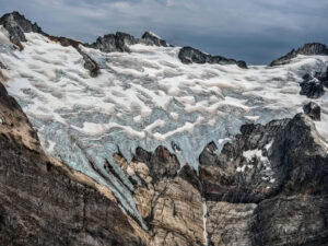A large glacier is shown in the mountains. Edward Burtynsky, Coast Mountains series.