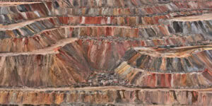 A large open excavated pit with many different colors in Kolwezi, Democratic Republic of Congo, 2024. Edward Burtynsky, image titled Dry Tailings #1.