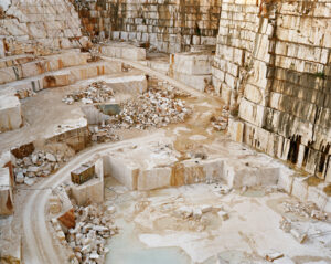 Excavated terrain showing tiered geological rock formations. Edward Burtynsky, Quarries series.