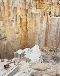 Aerial view of a quarry wall and people operating machinery. Edward Burtynsky, Quarries series.