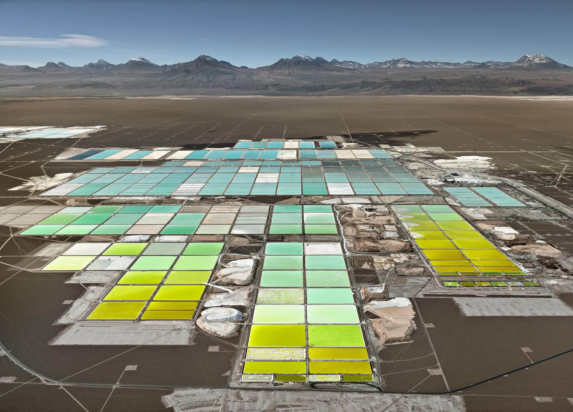 Overhead view of a large lithium evaporation grid with blue and green tones. Edward Burtynsky, Anthropocene