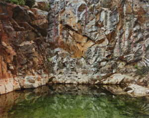 Still green water at base of rock wall. Edward Burtynsky Mines Quarries
