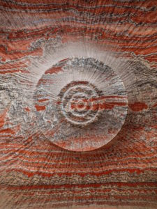 Red-toned view of drilled rock in a potash mine. Edward Burtynsky Anthropocene