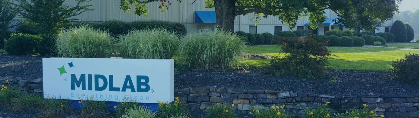 MIDLAB company sign outside landscaped office building