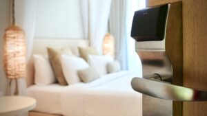 Electronic hotel room door lock with bedroom background