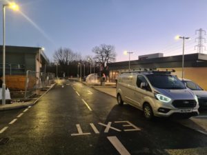 Nulectrics van in KFC Costa car park Bath Road in Chippenham. Lamp post lights on in wet weather.