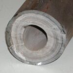 Limescale buildup on the inside of a heat exchanger pipe. Avoid this kind of water heater equipment damage by using soft water.