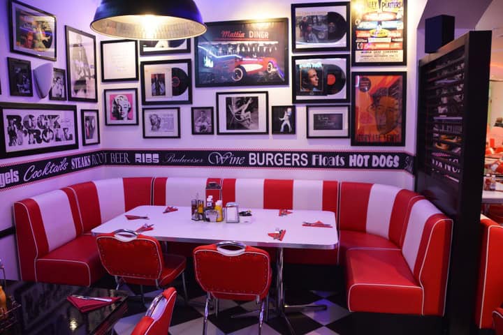 There’s nothing quite as charming as a photo gallery above the red and white striped booth of this diner wall.