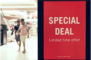 Shopper walking past a promotional sign for limited-time retail discounts.