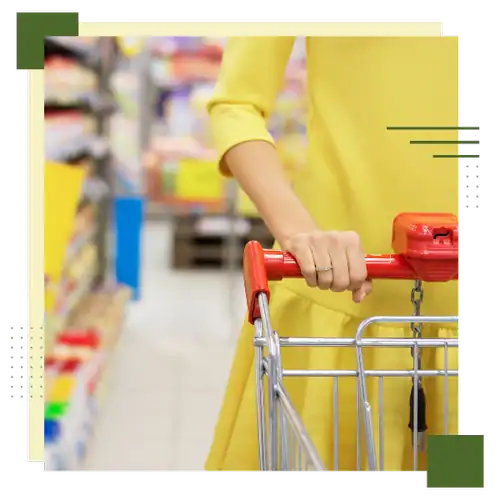 Shopper holding shopping cart in store aisle, consumer behavior analysis.