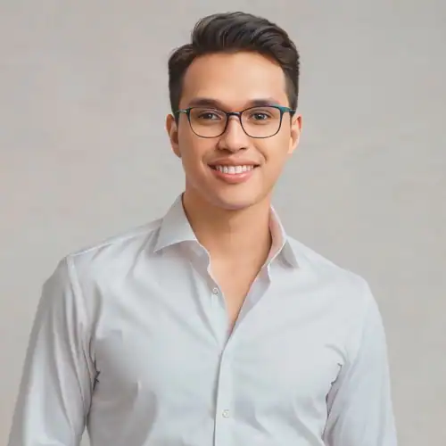 Professional team member smiling in a white shirt for Revology Analytics.