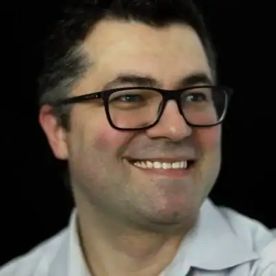 Diverse team working together in an office environment at Revology Analytics.