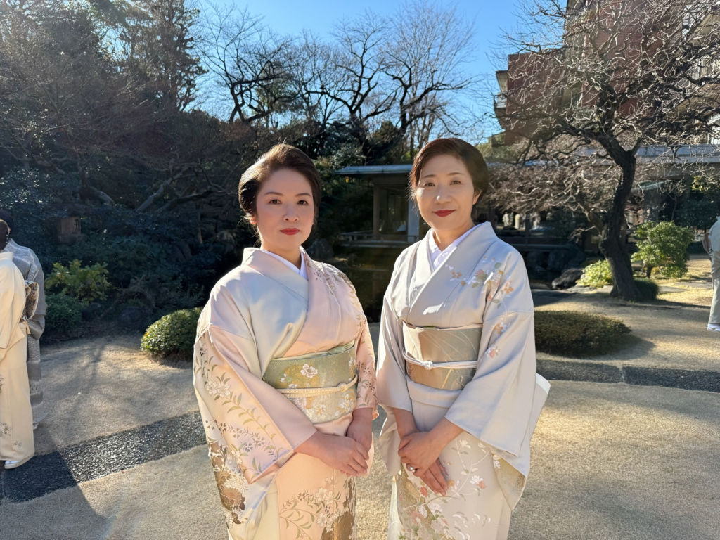 Elegant women in traditional kimonos at Shinjuku Nagauta Shamisen class during outdoor event.