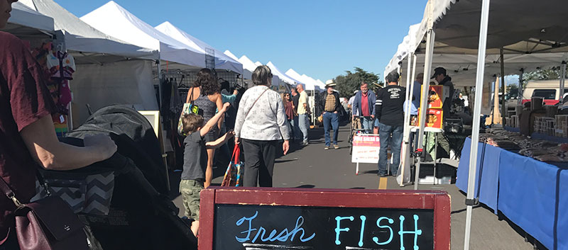 Tents line the walkway at the Channel Islands Farmers' Market