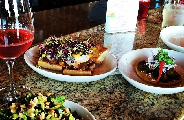 Open-face breakfast toast with eggs and bacon, topped with fresh micro-greens