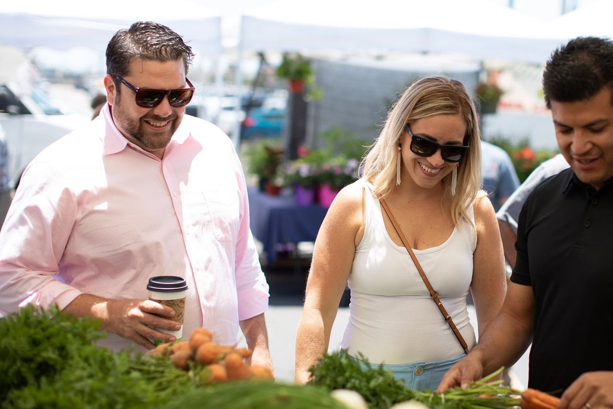 A couple peruses fresh produce at the CIH Farmers' Market