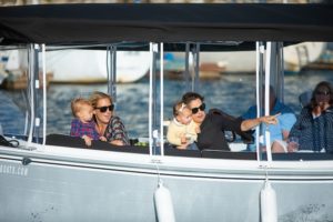 Moms and their kids enjoying a boat tour on the harbor