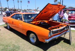 A mint Plymouth Roadrunner with its hood popped at the CIH Father's Day car show
