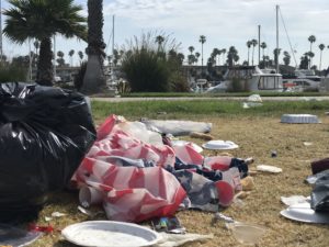 Closeup of a discarded American flag and other 4th of July trash
