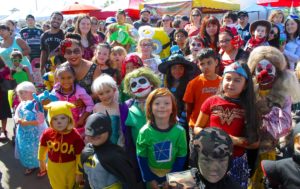Smiling, costumed kids at Farmers Market Pumpkin Fun Day