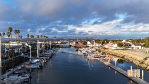 Scenic view of Channel Islands Harbor with boats, palm trees, and waterfront homes.