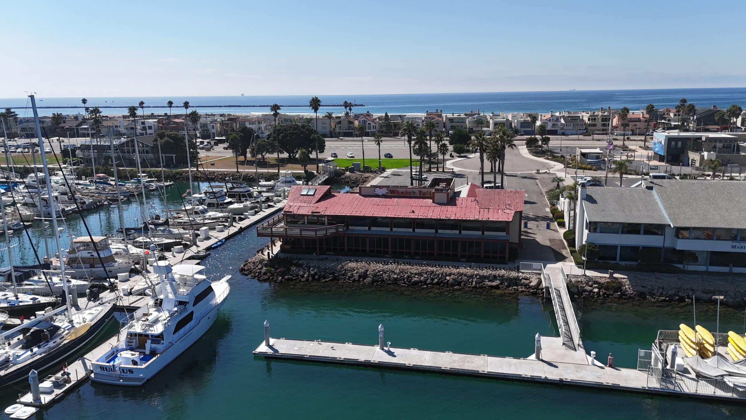 Aerial view of Channel Islands Harbor marina with boats and waterfront buildings.