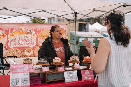 Vendor selling cheesecakes at Channel Islands Harbor during fireworks event.