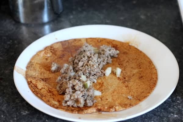 cheeseburger enchilada being filled