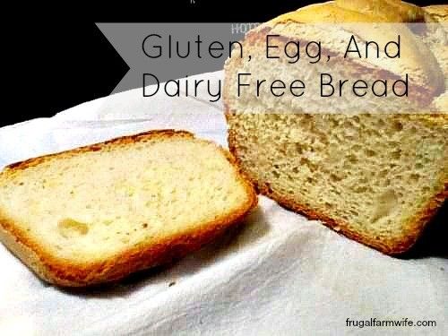 Image shows a loaf of bread on a white napkin with one slice cut off the end. Text overlay reads "Gluten, Egg and Dairy Free Bread"