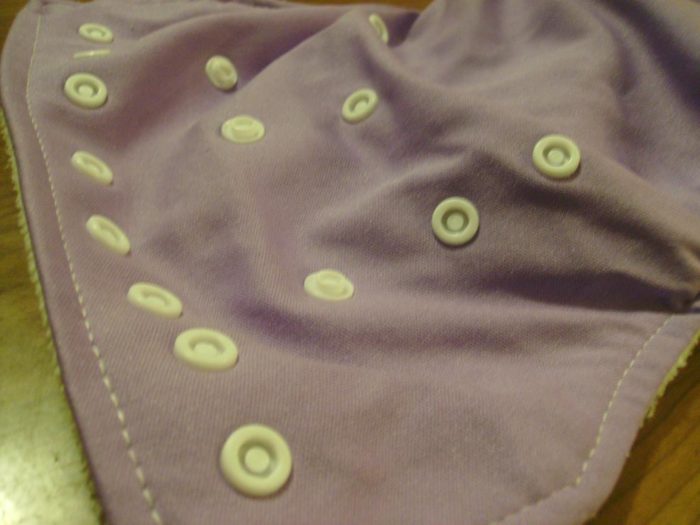 Image shows a close up of the snaps on a cloth diaper