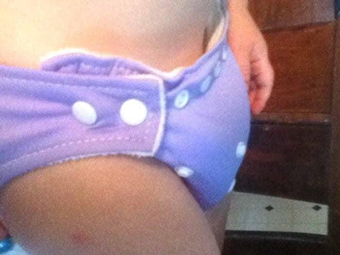 Image shows a close up of an toddler's waist to illustrate fit of cloth diaper