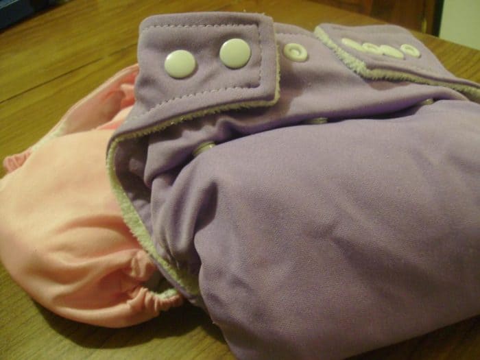 Image shows two cloth diapers, one pink and one purple