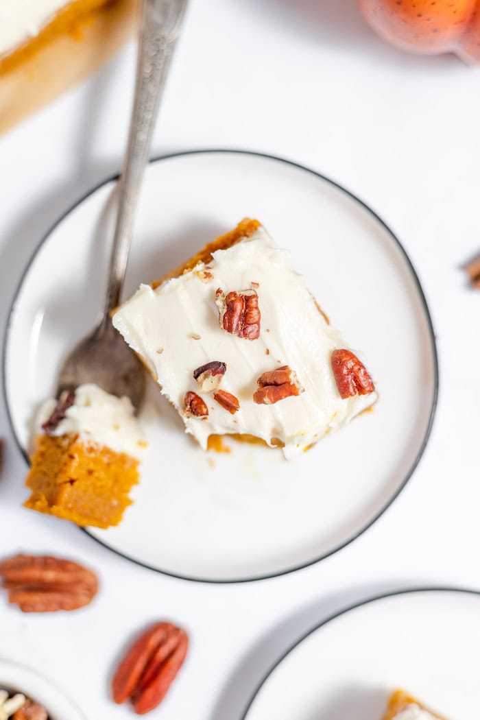 cream cheese frosting on a pumpkin bar