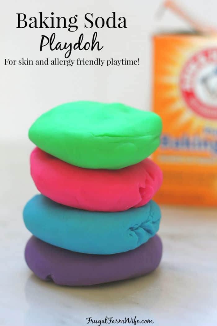 Image shows 4 colors of baking soda play dough stacked on one another, with a box of Arm & Hammer Baking Soda in the background
