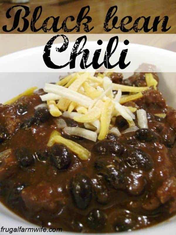 Image shows a close up of a bowl of black bean chili with cheese sprinkled on top. Text above reads "Black Bean Chili"