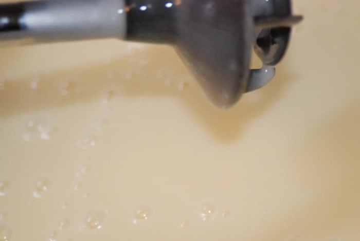 Image shows an immersion blender above a bowl